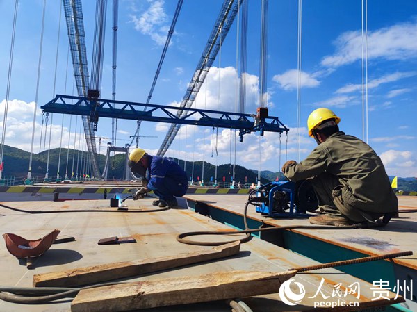 工人作大橋合龍前最后準(zhǔn)備工作。人民網(wǎng) 李麗萍攝