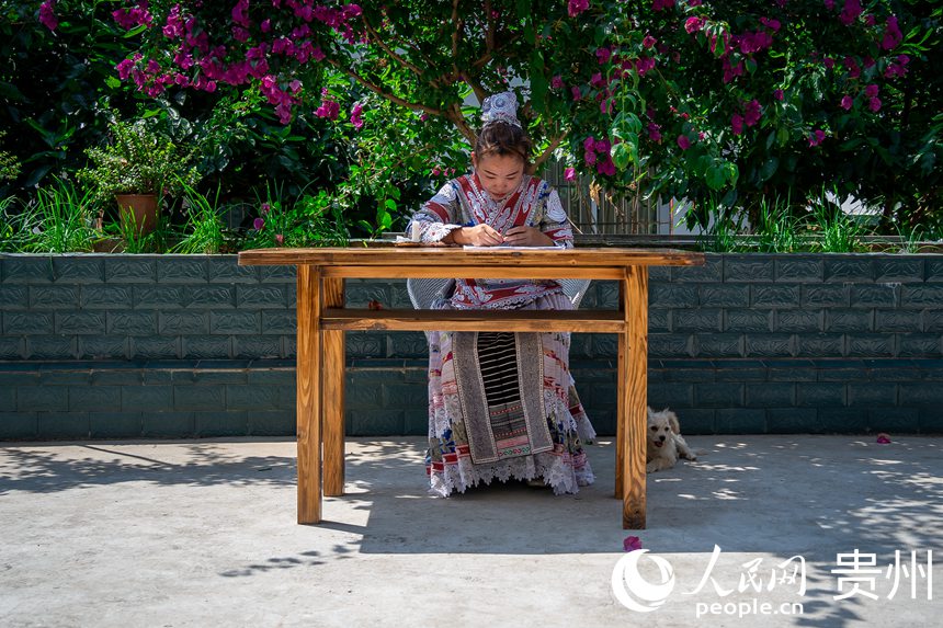 化屋村異地扶貧搬遷點內，苗族同胞正在制作苗族傳統蠟染。人民網 涂敏攝