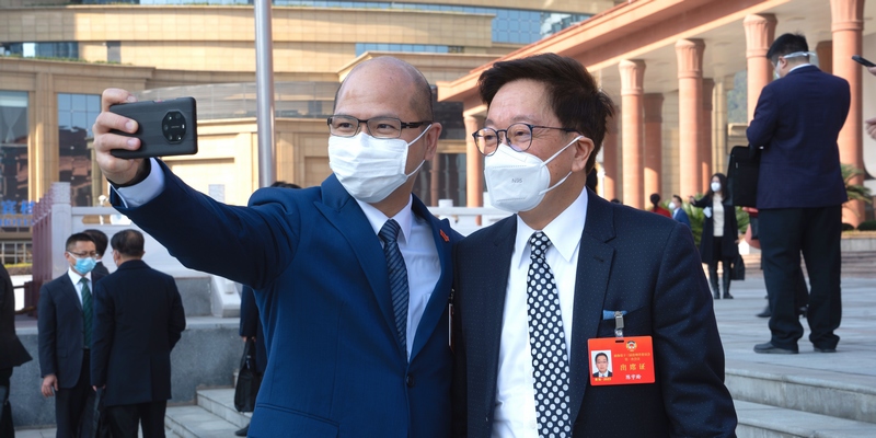 政協委員站在會議中心門口合影留念。人民網 陽茜攝