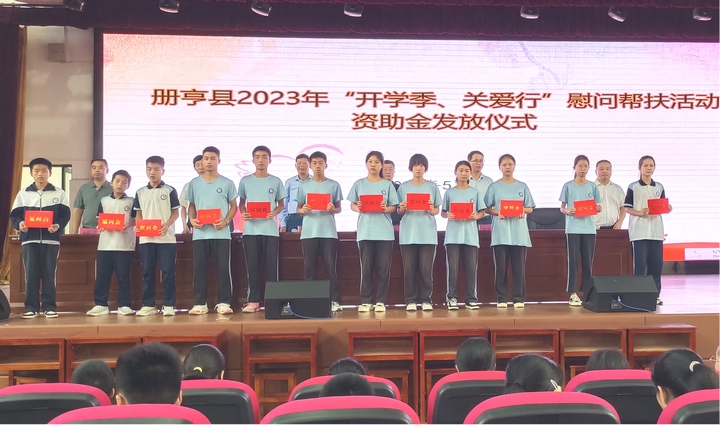 圖為在冊亨縣第三中學(xué)發(fā)放資助金。