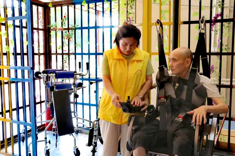 護理員組織老人開展康復理療。