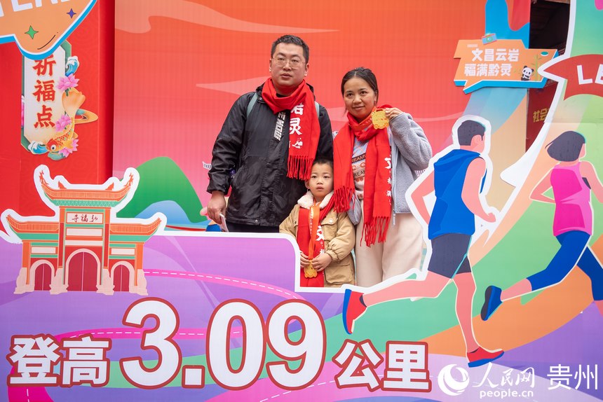 參與貴陽貴安第53屆全民健身登高迎新跑的市民在終點打卡拍照。人民網記者 涂敏攝