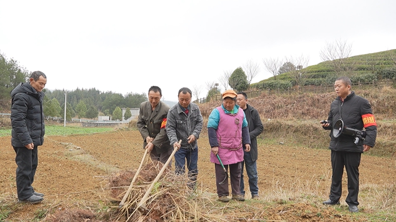 思南縣張家寨鎮護林員到田間地頭對村民進行宣傳。(陳敏 攝)