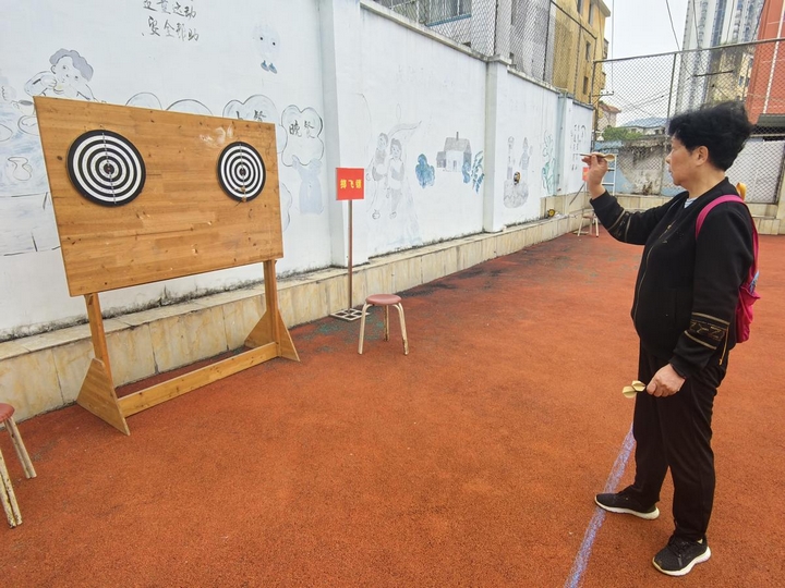 圖為退休干部參與投擲飛鏢項(xiàng)目。