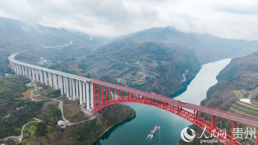 在烏江上航行的航電657號貨船與德余烏江特大橋同框。人民網記者 涂敏攝
