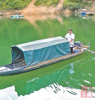 龍光慶在擺渡過河。姚晶權攝
