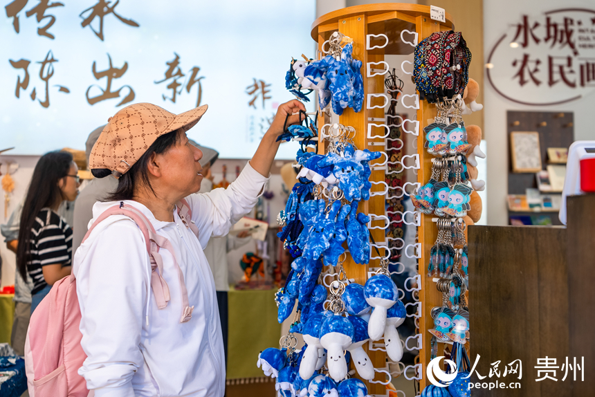 游客在景區(qū)內(nèi)的文創(chuàng)商品店選購(gòu)紀(jì)念品。人民網(wǎng)記者 涂敏攝