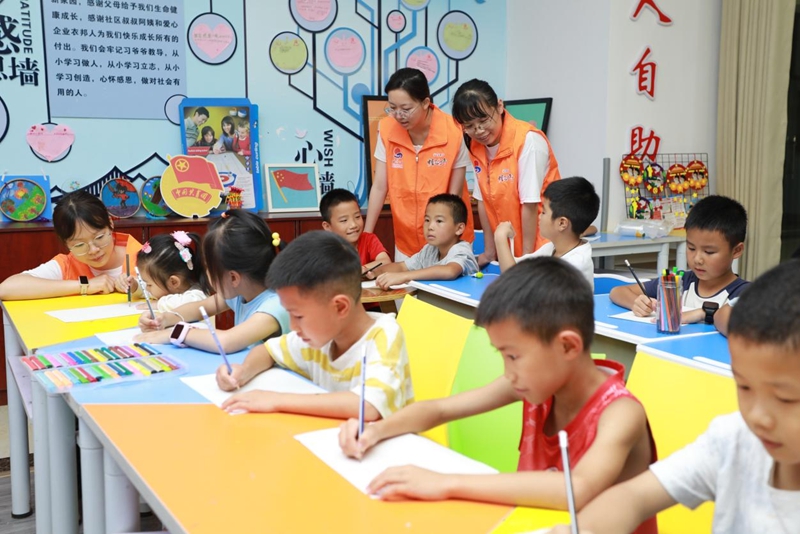 在凱里市福和社區,志愿者、社工組成的陪伴隊伍陪伴孩子們描繪自己的航天世界。共青團貴州省委 供圖