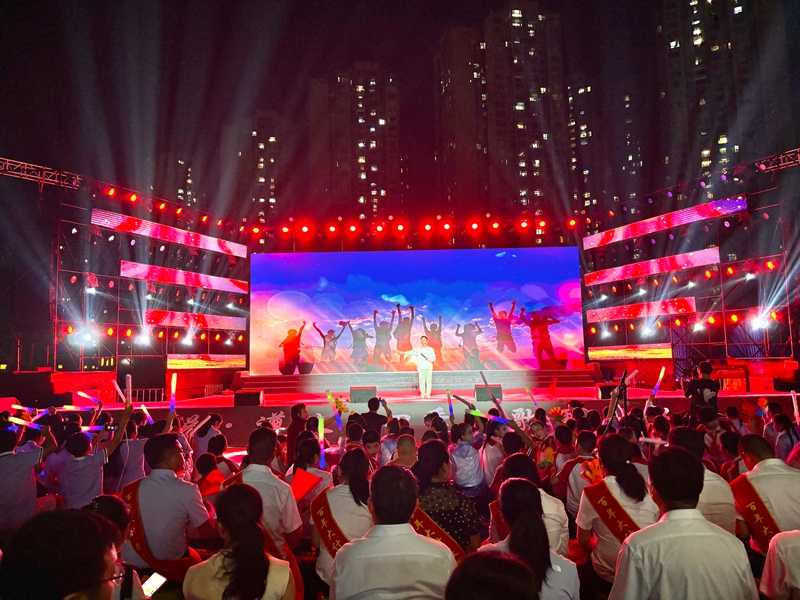 舞臺上表演者在絢麗背景與燈光下傾情演出,臺下觀眾熱情高漲,氛圍熱烈。張川 攝.jpg