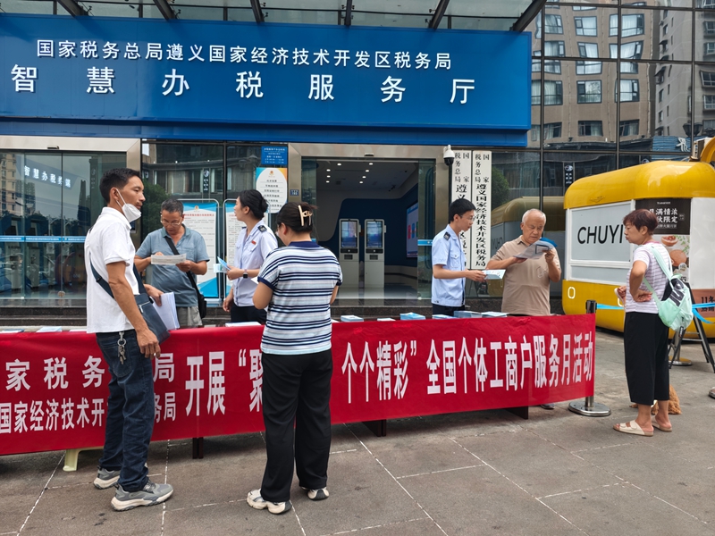 稅務(wù)干部發(fā)放個(gè)體工商戶稅收優(yōu)惠折頁(yè)手冊(cè)(王寧 攝)